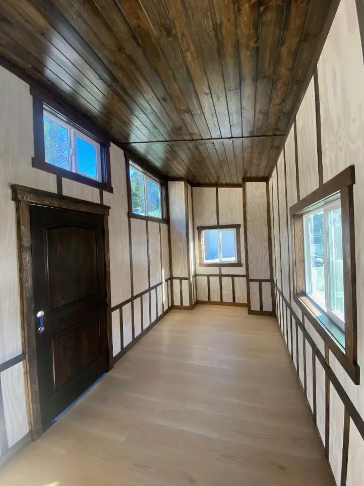 Narrow tiny house interior with wood plank ceiling and trim