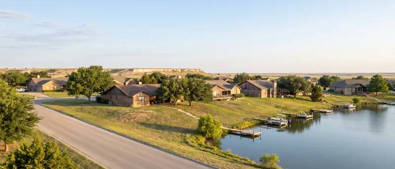 Winding road along the lake shore in Ransom Canyon with homes stepped up the canyon wall