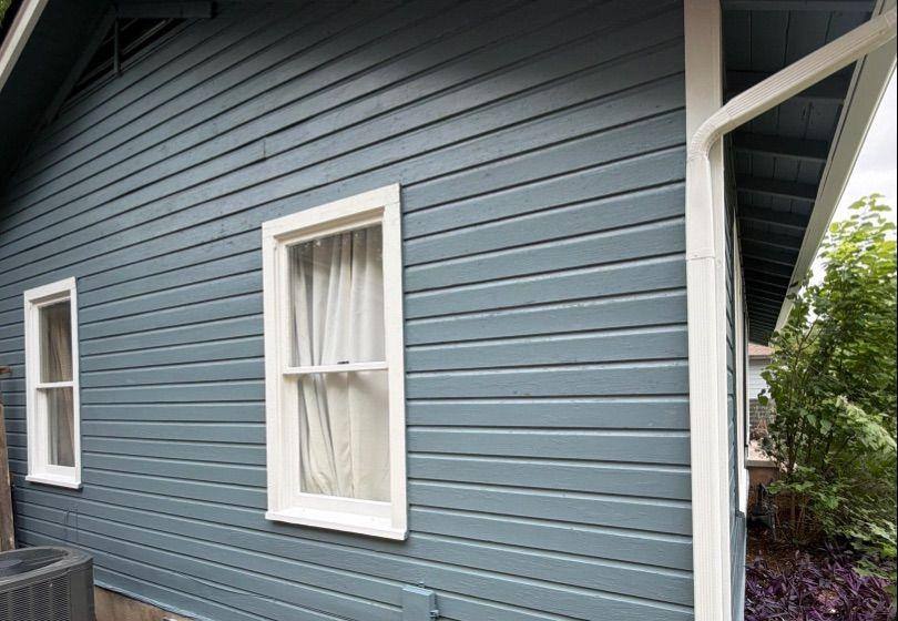 Before and after photo of exterior siding repainted by Hill Country Painting in Austin, TX