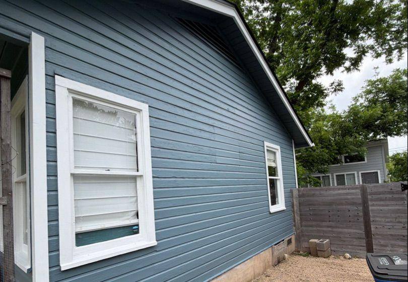 Before and after photo of the back corner of a house repainted by Hill Country Painting in Austin, TX