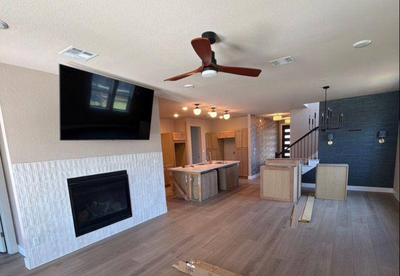 Before and after photo of a living room and kitchen repainted by Hill Country Painting in Dripping Springs, TX