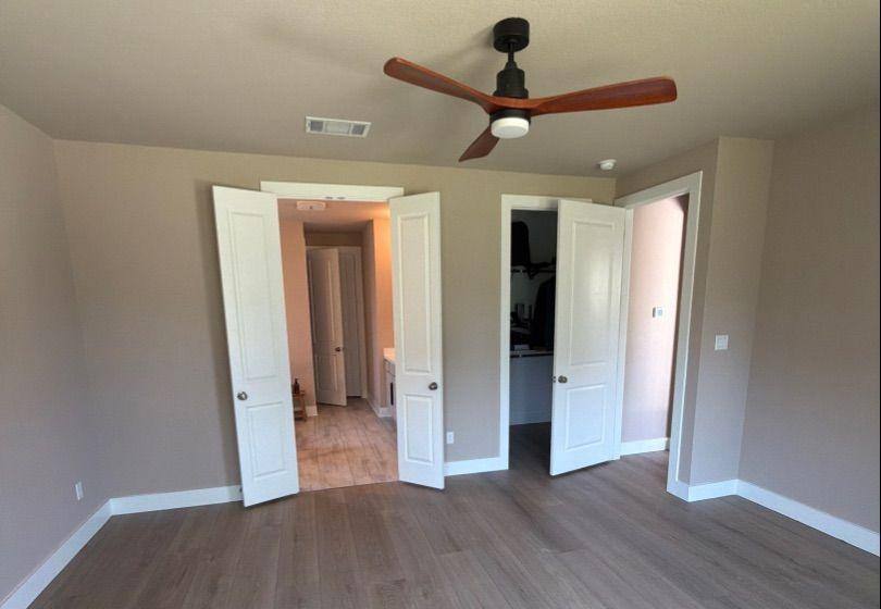 Before and after photo of a master bedroom repainted by Hill Country Painting in Dripping Springs, TX