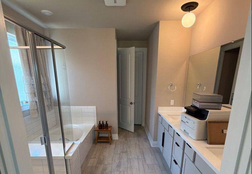 Before and after photo of a master bathroom repainted by Hill Country Painting in Dripping Springs, TX