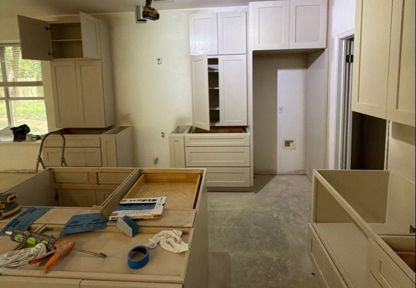 Before and after photo of kitchen cabinets refinished by Hill Country Painting in Round Rock, TX