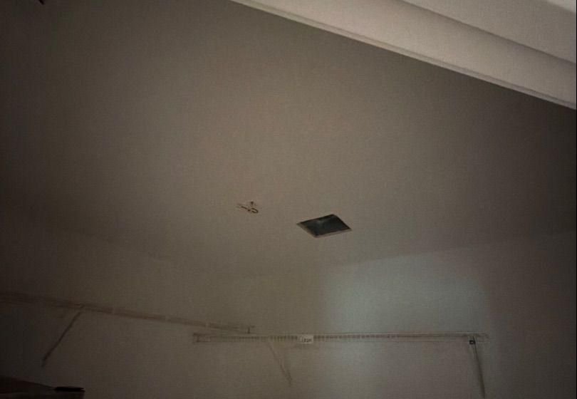 Before and after photo of a repaired ceiling repainted by Hill Country Painting in Dripping Springs, TX