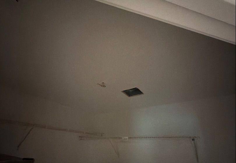 Before and after photo of a repaired ceiling repainted by Hill Country Painting in Dripping Springs, TX