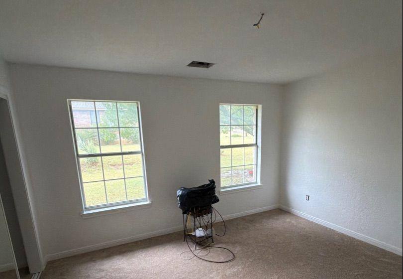Before and after photo of a bright bedroom repainted by Hill Country Painting in Dripping Springs, TX