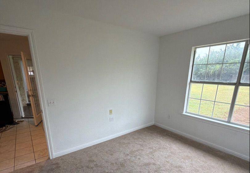 Before and after photo of a bedroom repainted by Hill Country Painting in Dripping Springs, TX