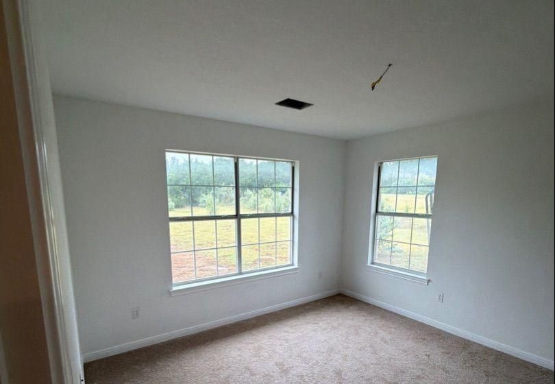 Before and after photo of a bedroom repainted by Hill Country Painting in Dripping Springs, TX