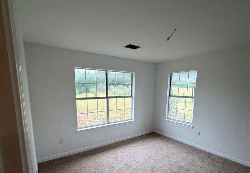 Before and after photo of a bedroom repainted by Hill Country Painting in Dripping Springs, TX