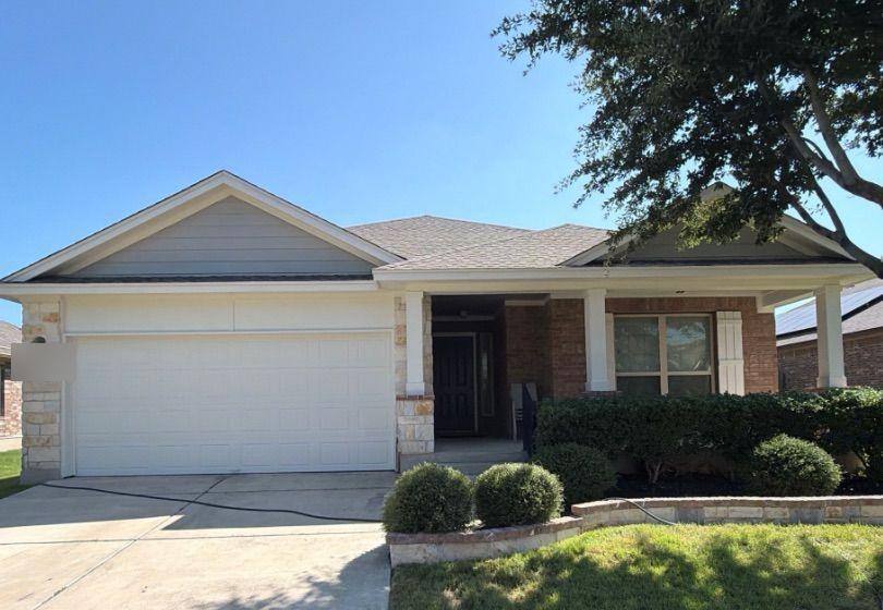Before and after photo of a house exterior repainted by Hill Country Painting in Pflugerville, TX