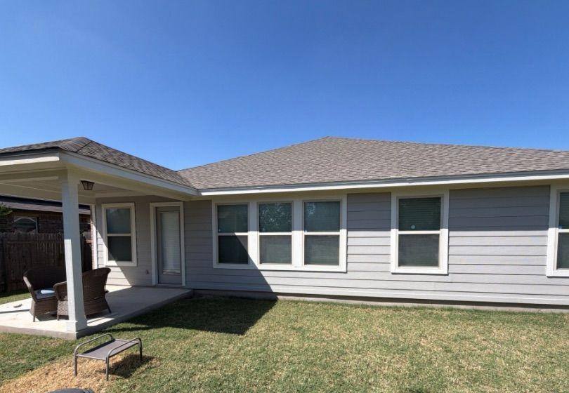 Before and after photo of the back of a house repainted by Hill Country Painting in Pflugerville, TX