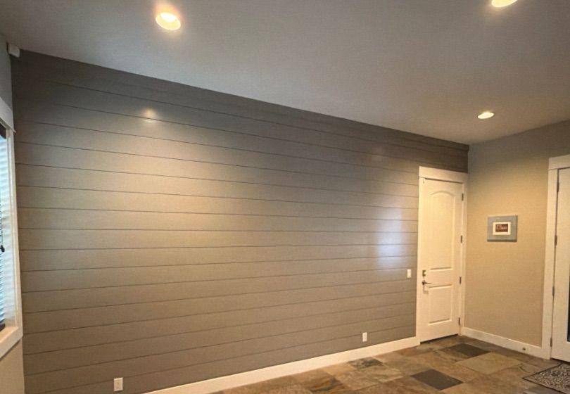 Before and after photo of an entry way accent wall repainted by Hill Country Painting in Spicewood, TX