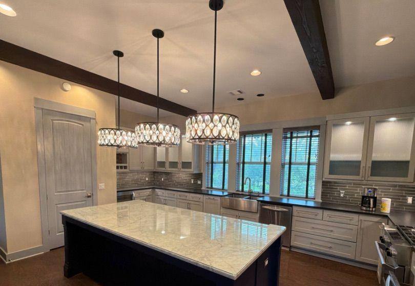 Before and after photo of a kitchen island painted by Hill Country Painting in Spicewood, TX