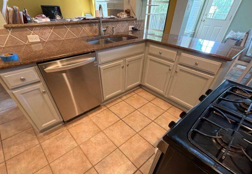 Before and after photo of kitchen cabinets painted by Hill Country Painting in Round Rock, TX
