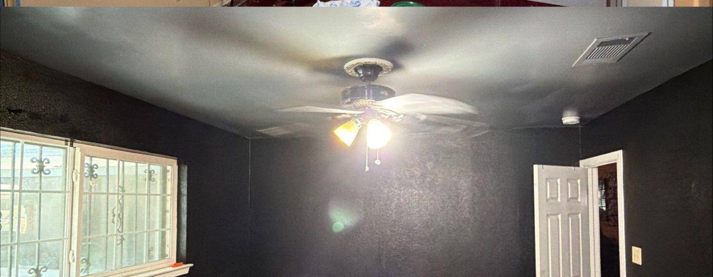 Before and after photo of a bedroom water damage repair and repaint by Hill Country Painting in Austin, TX
