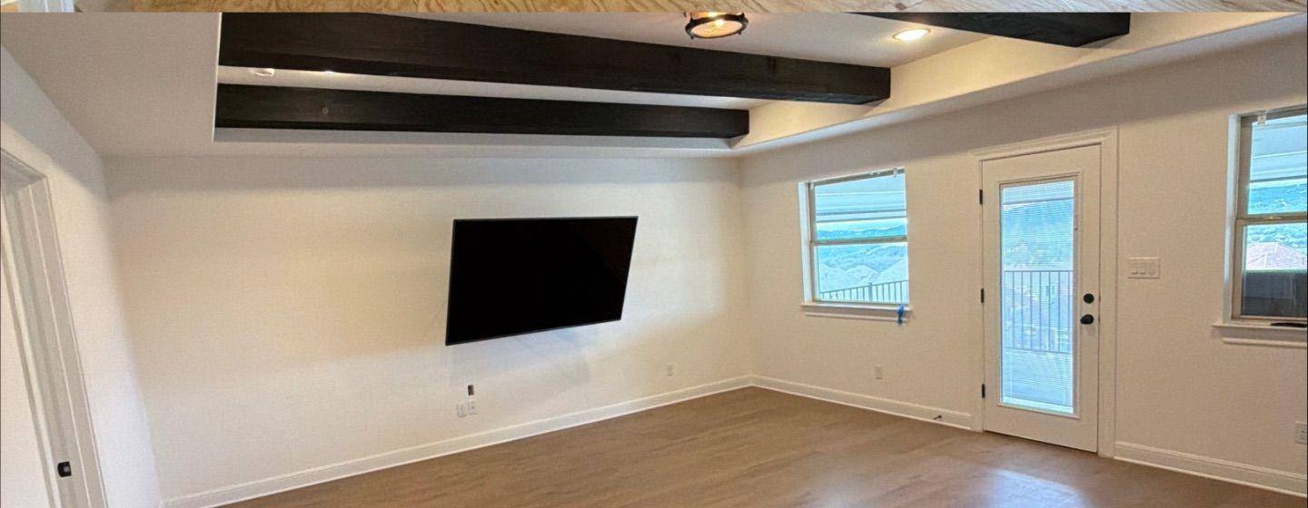 Before and after photo of an upstairs living room painted by Hill Country Painting in Leander, TX