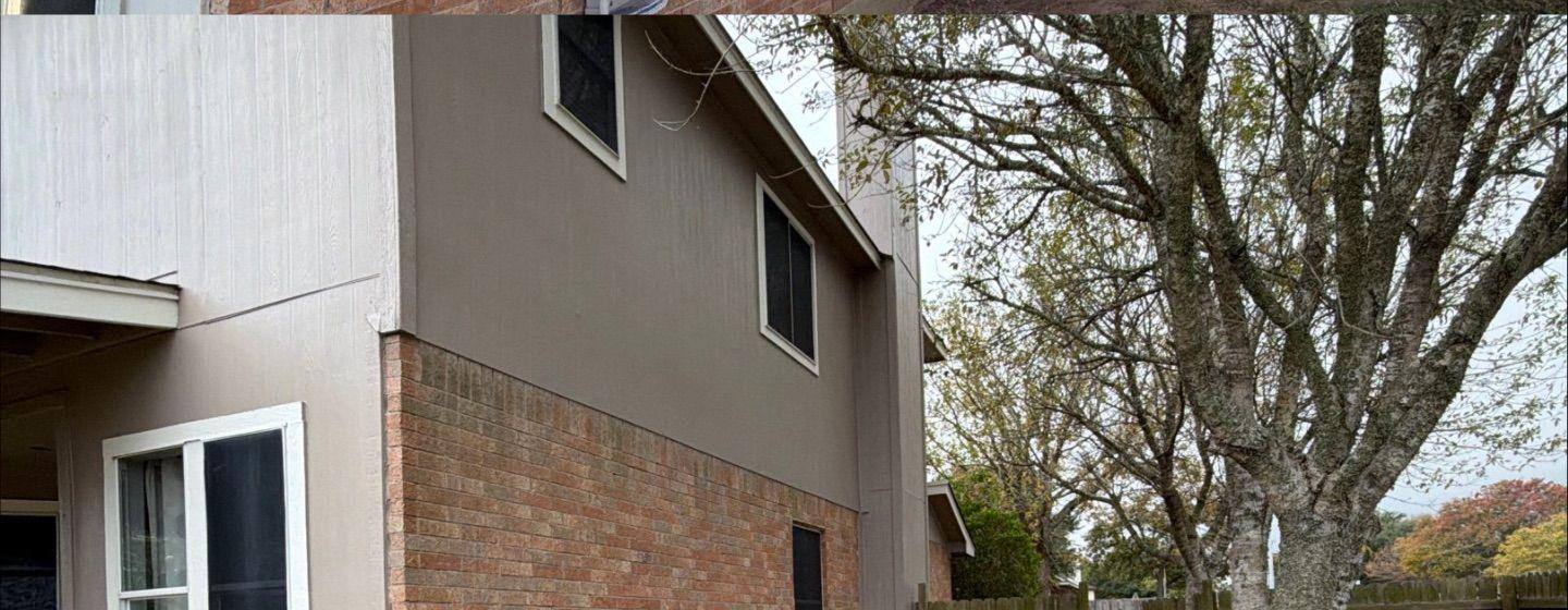 Before and after photo of a house exterior side painted by Hill Country Painting in Lockhart, TX