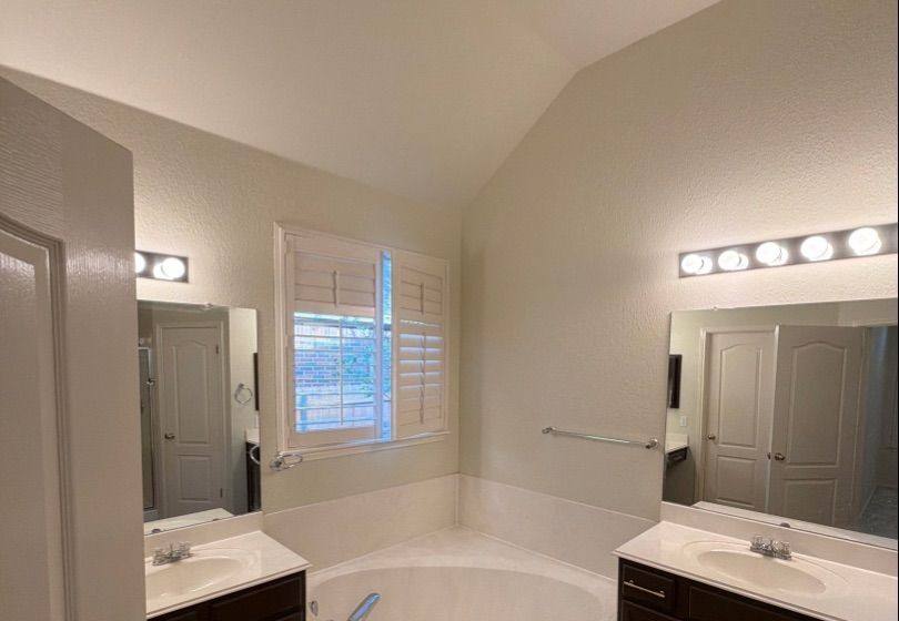 Before and after photo of a master bathroom painted by Hill Country Painting in Cedar Park, TX