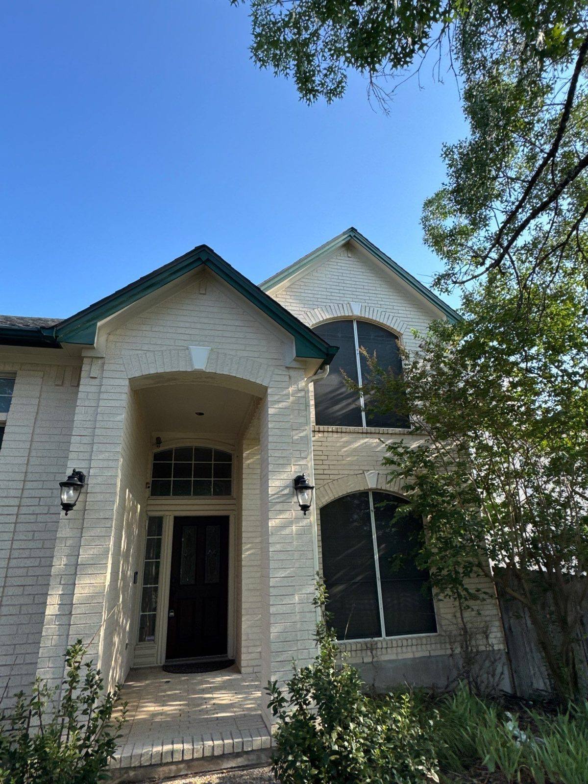 Front entry of a two-story home in Austin, TX prior to exterior repainting by Hill Country Painting