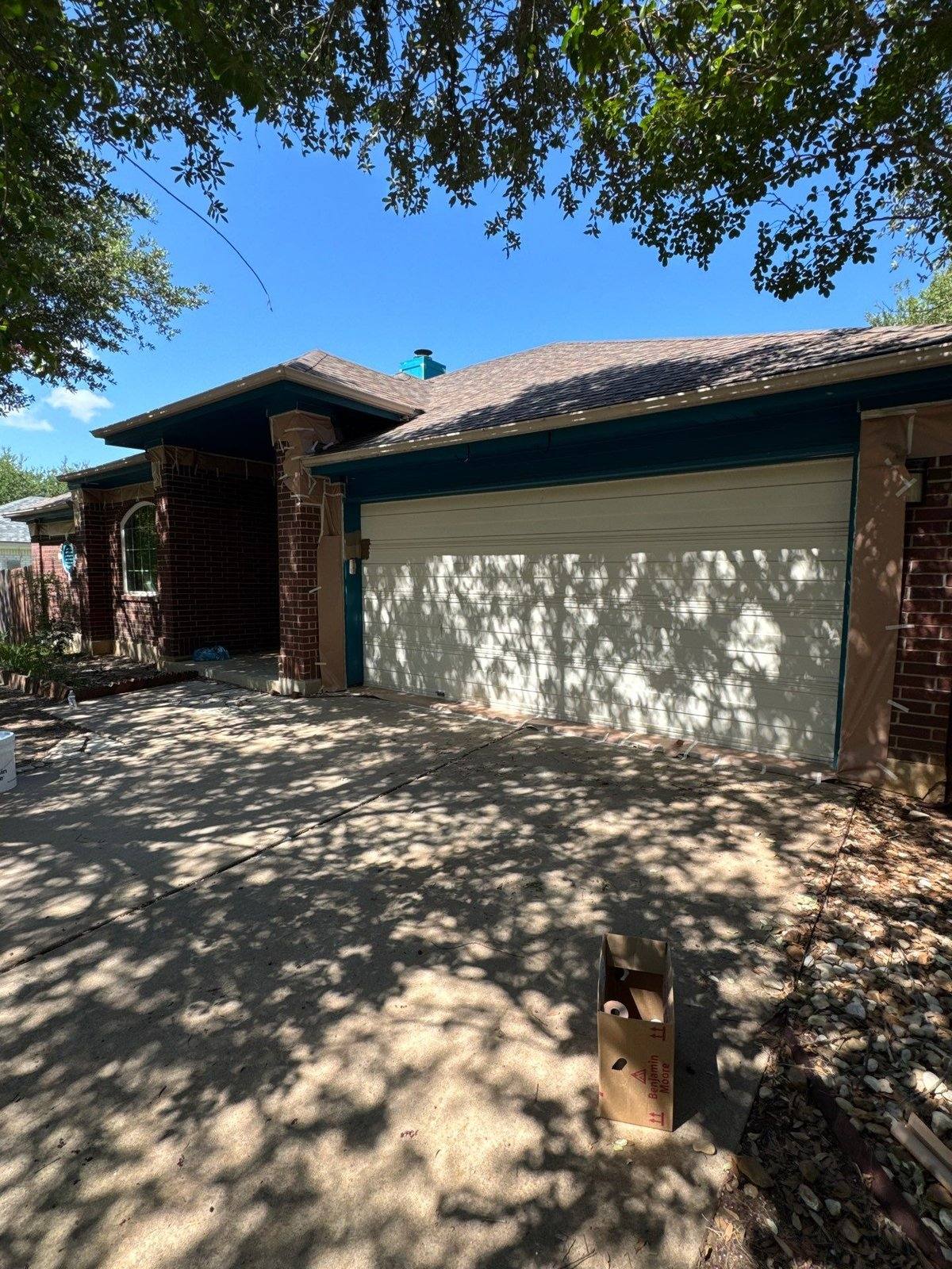 Front exterior of a home in Austin, TX prior to a three-tone exterior repaint by Hill Country Painting