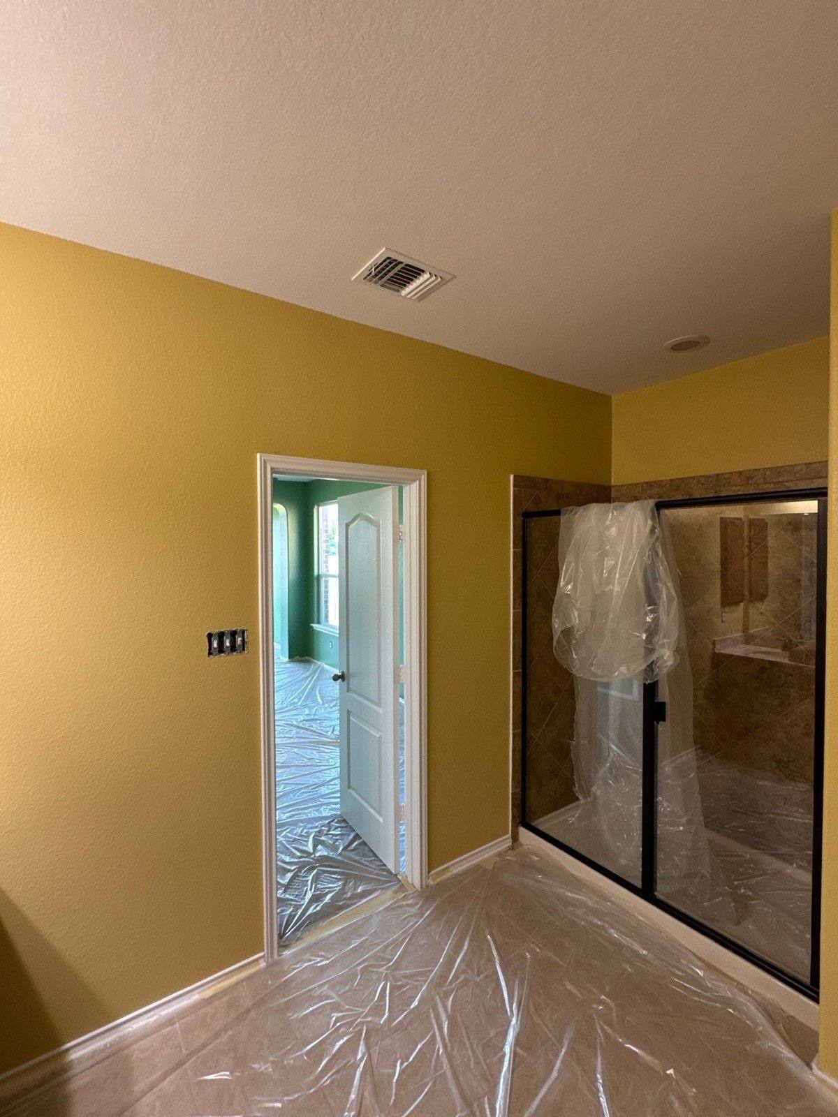 Bathroom in a Pflugerville, TX home prepped with plastic sheeting ahead of interior wall painting by Hill Country Painting