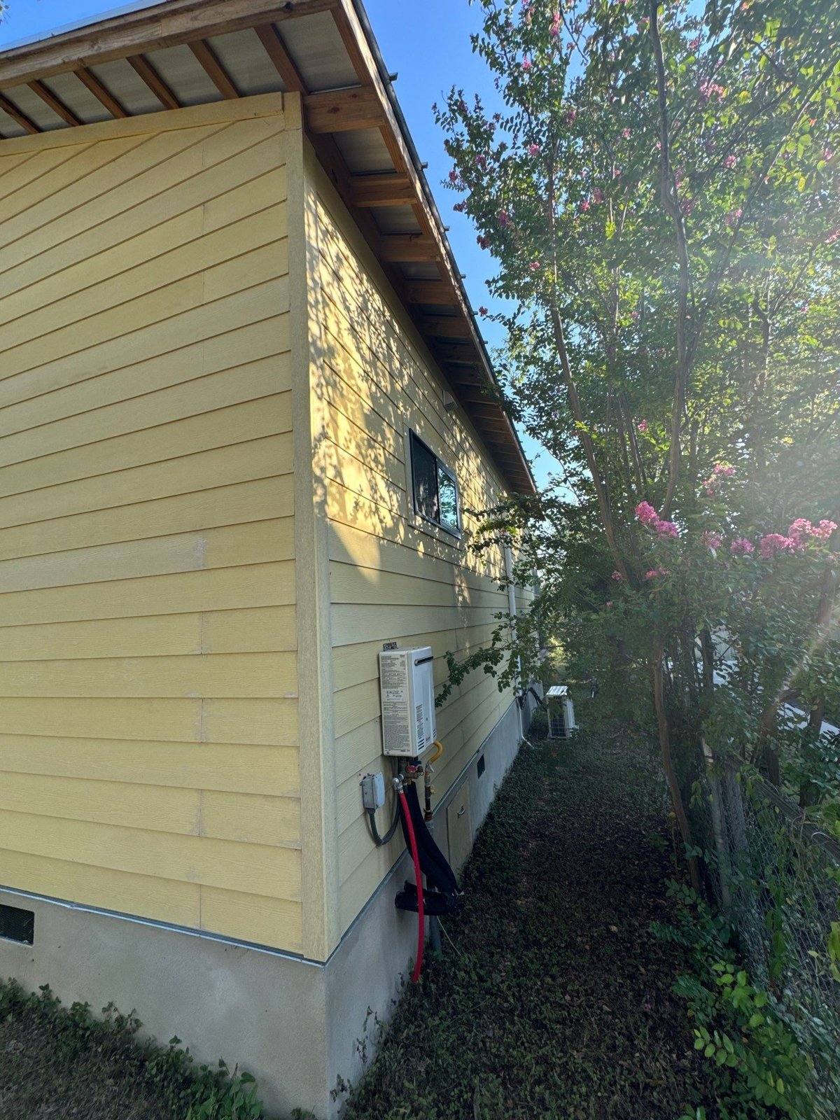 Side exterior of a home in Austin, TX with Hardie siding ahead of exterior painting by Hill Country Painting