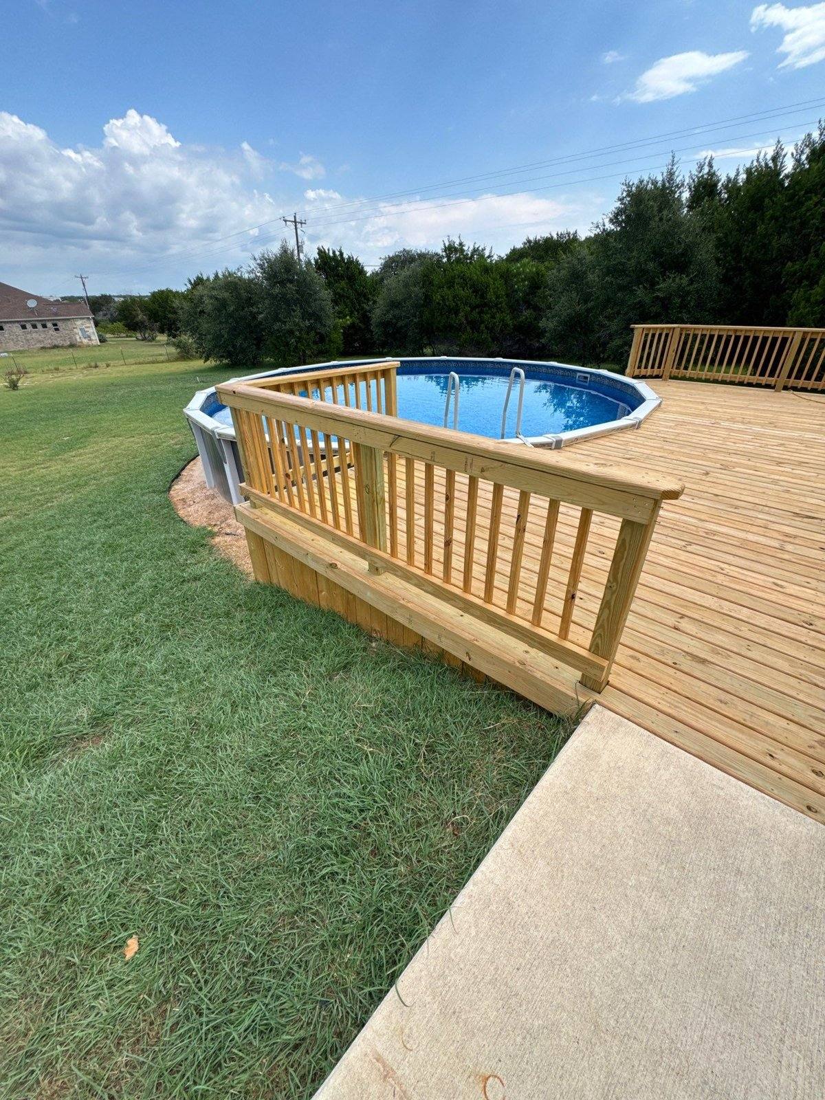 New wood deck and above-ground pool at a home in Liberty Hill, TX ahead of staining by Hill Country Painting