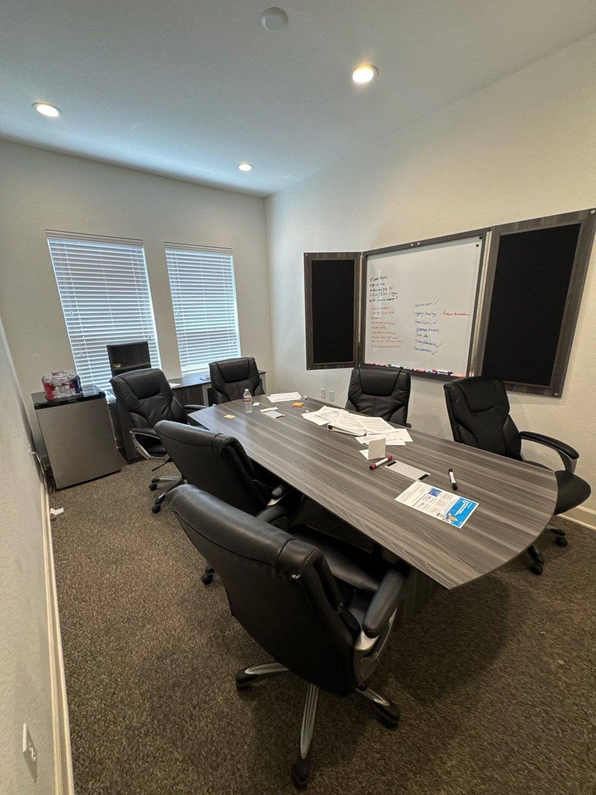 Conference room prepped ahead of an interior repaint at an office suite in Round Rock, TX by Hill Country Painting