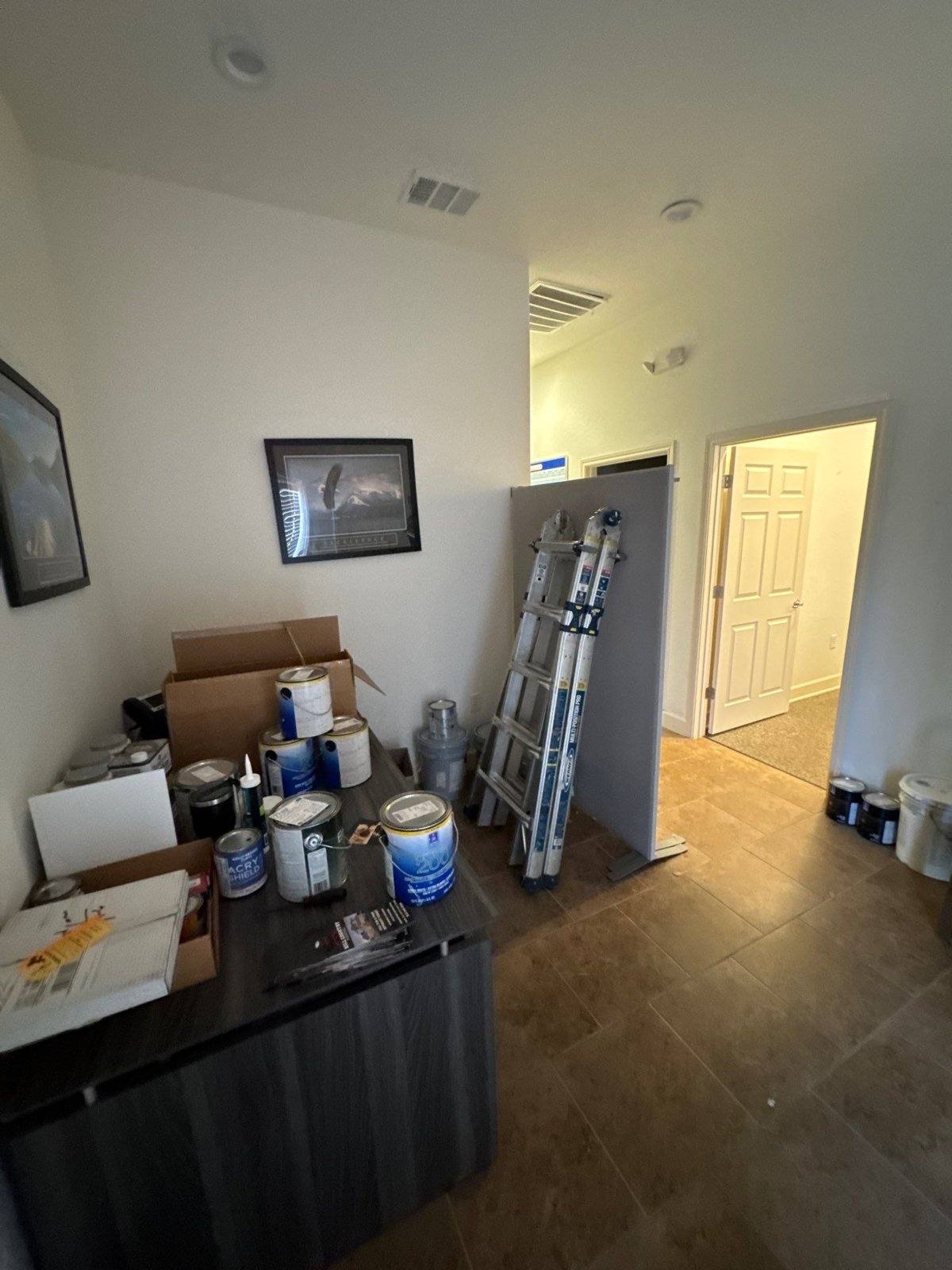 Entryway staged with painting supplies ahead of an office suite repaint in Round Rock, TX by Hill Country Painting