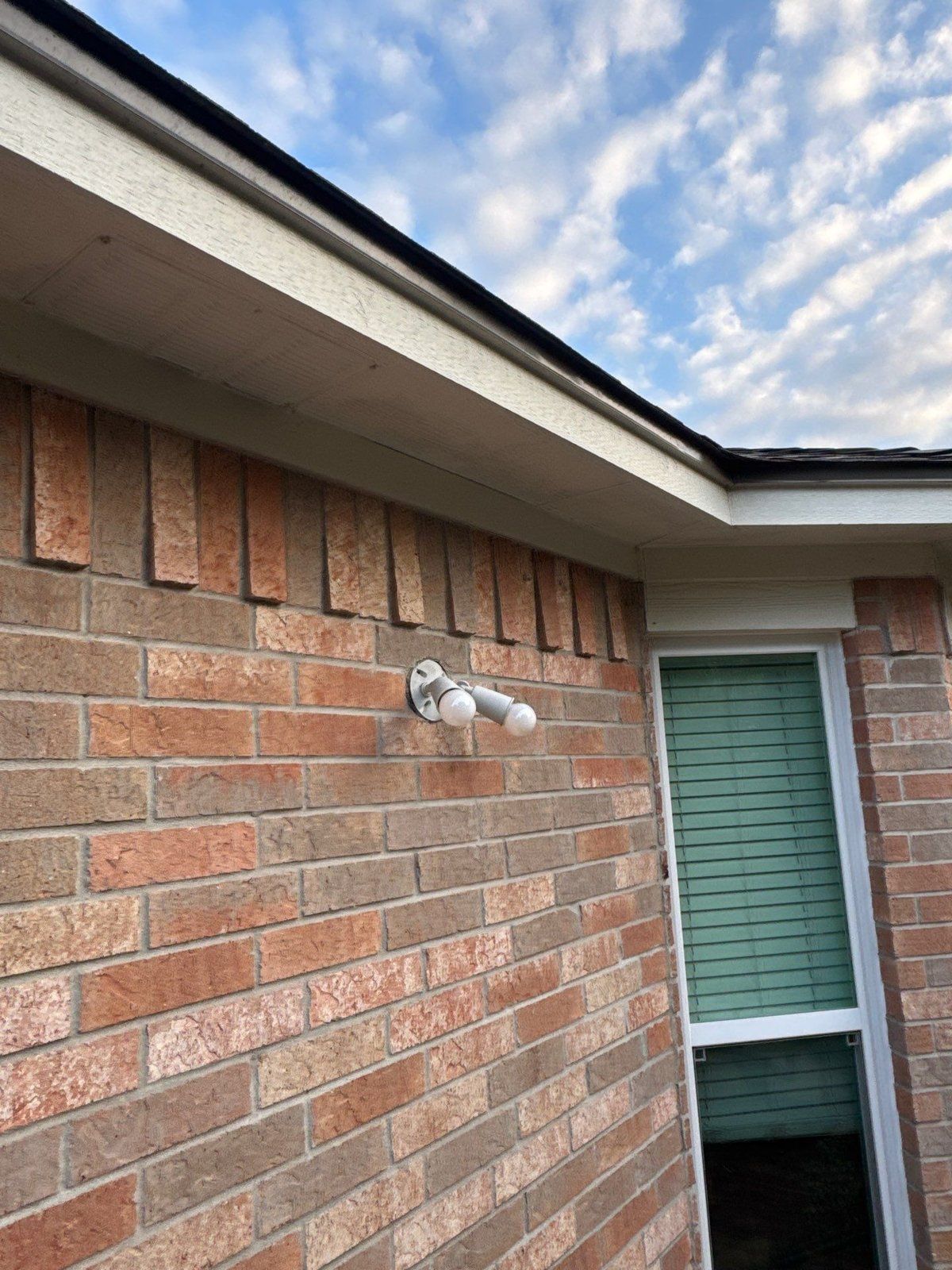 Brick corner with soffit, fascia, and window trim ahead of an exterior repaint in Pflugerville, TX by Hill Country Painting