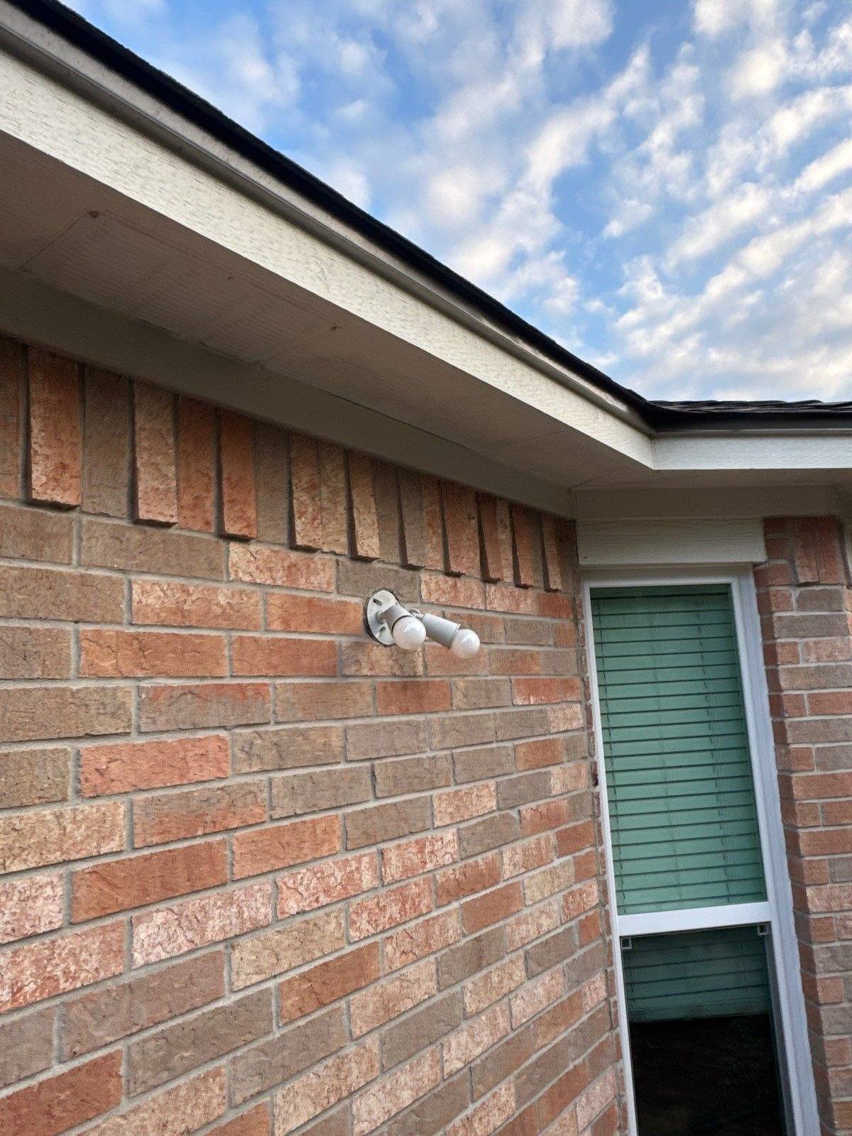 Brick corner with soffit, fascia, and window trim ahead of an exterior repaint in Pflugerville, TX by Hill Country Painting