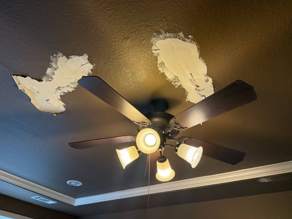 Ceiling drywall patches around a light fixture ahead of texture matching and repaint in Driftwood, TX by Hill Country Painting