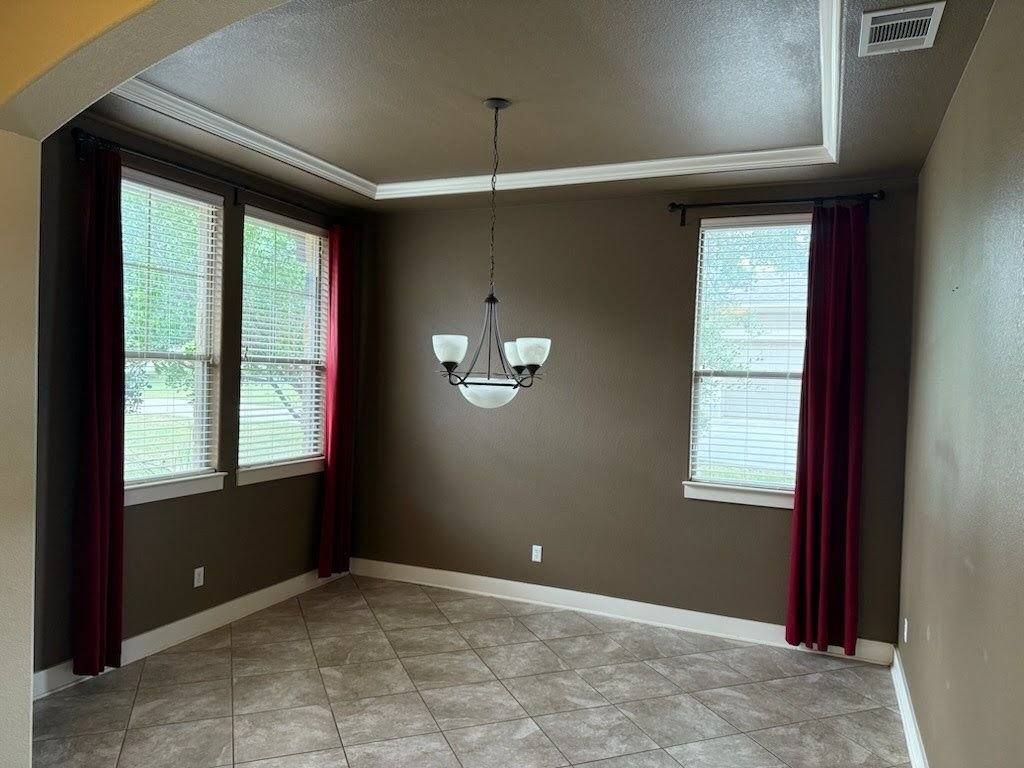 Front room with tray ceiling and crown molding ahead of drywall repair and repaint in Driftwood, TX by Hill Country Painting
