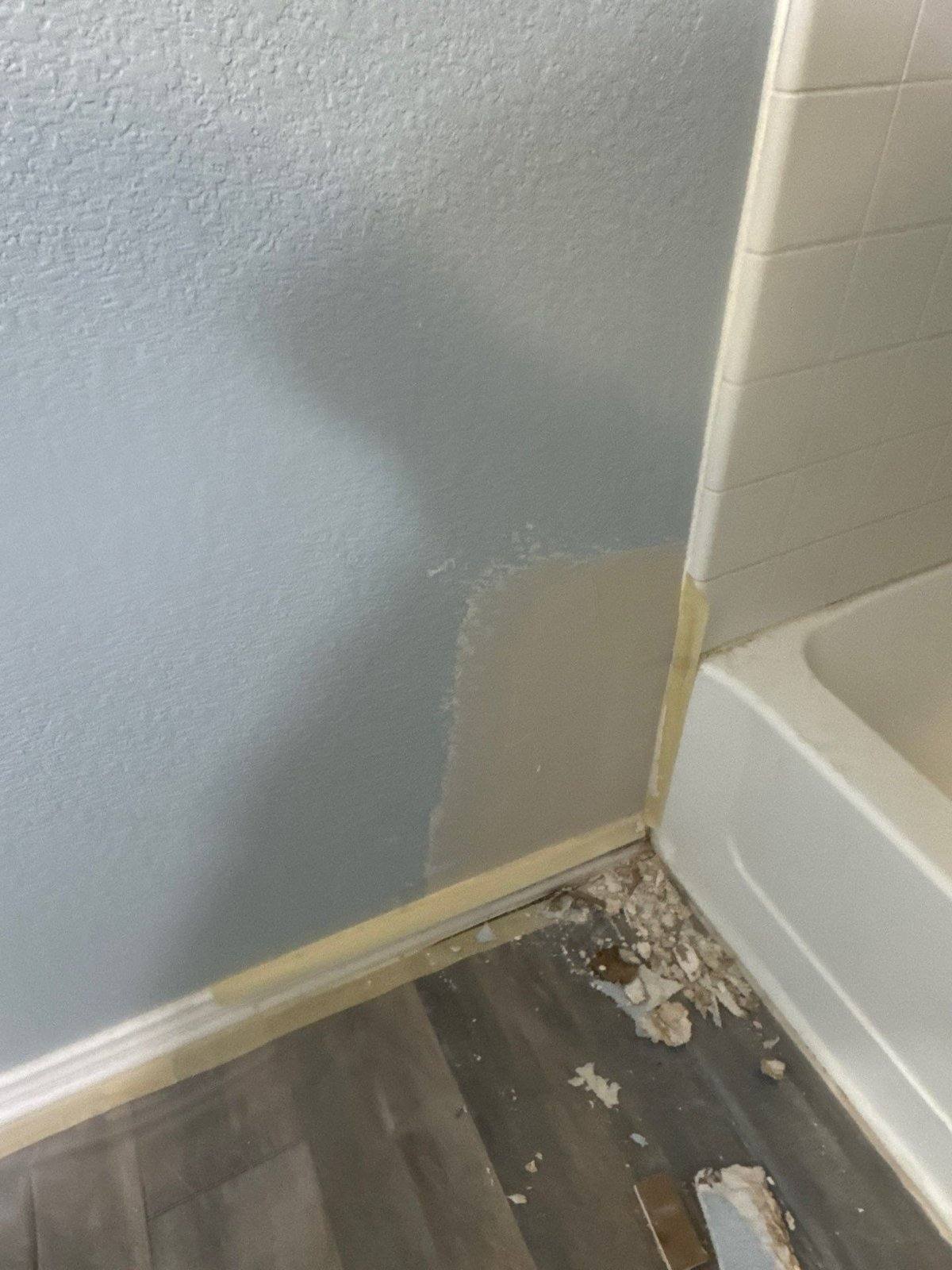 Drywall repair near the tub in the upstairs bathroom, ahead of repainting, in Leander, TX by Hill Country Painting