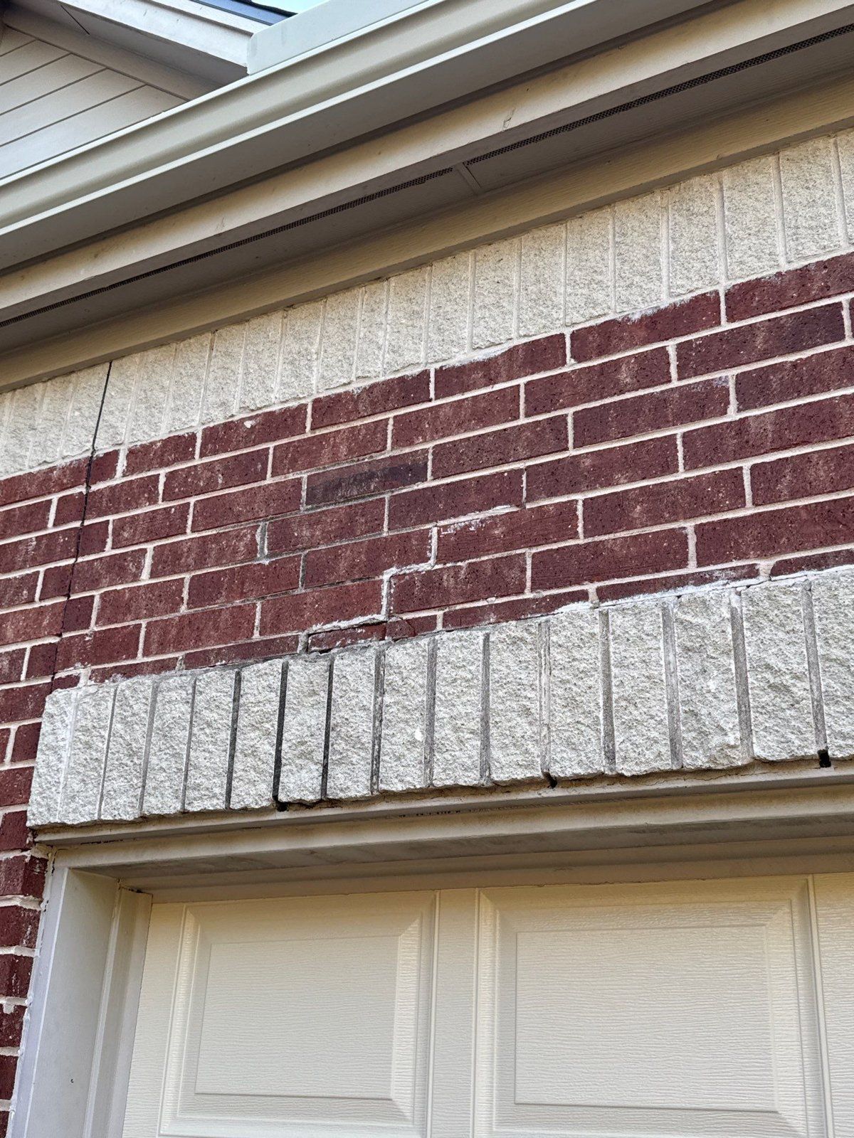 Cracked brick near the roofline, documented ahead of exterior repair work in Round Rock, TX by Hill Country Painting