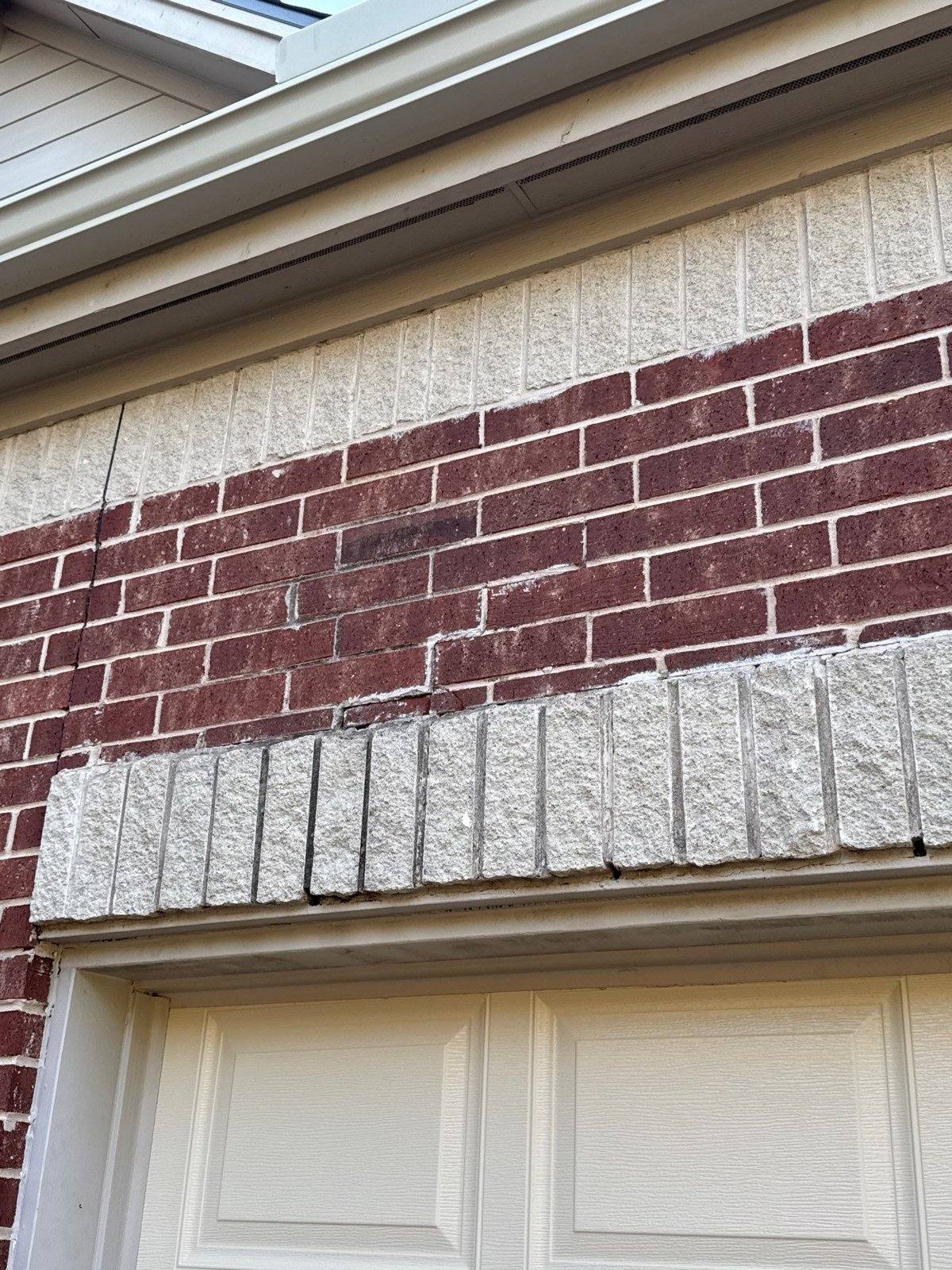 Cracked brick near the roofline, documented ahead of exterior repair work in Round Rock, TX by Hill Country Painting