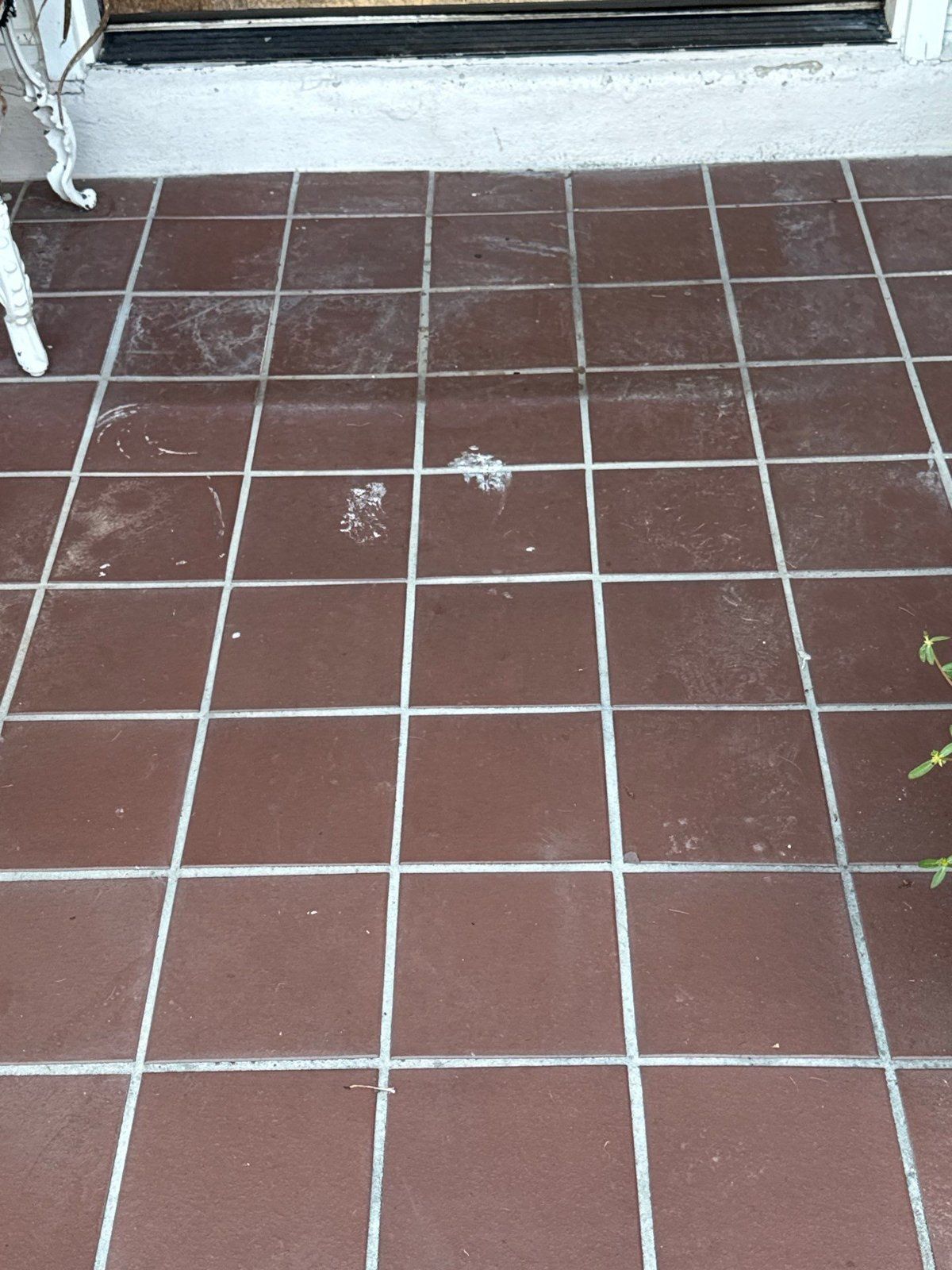 Existing paint staining on the front entry tile, documented ahead of work in Round Rock, TX by Hill Country Painting