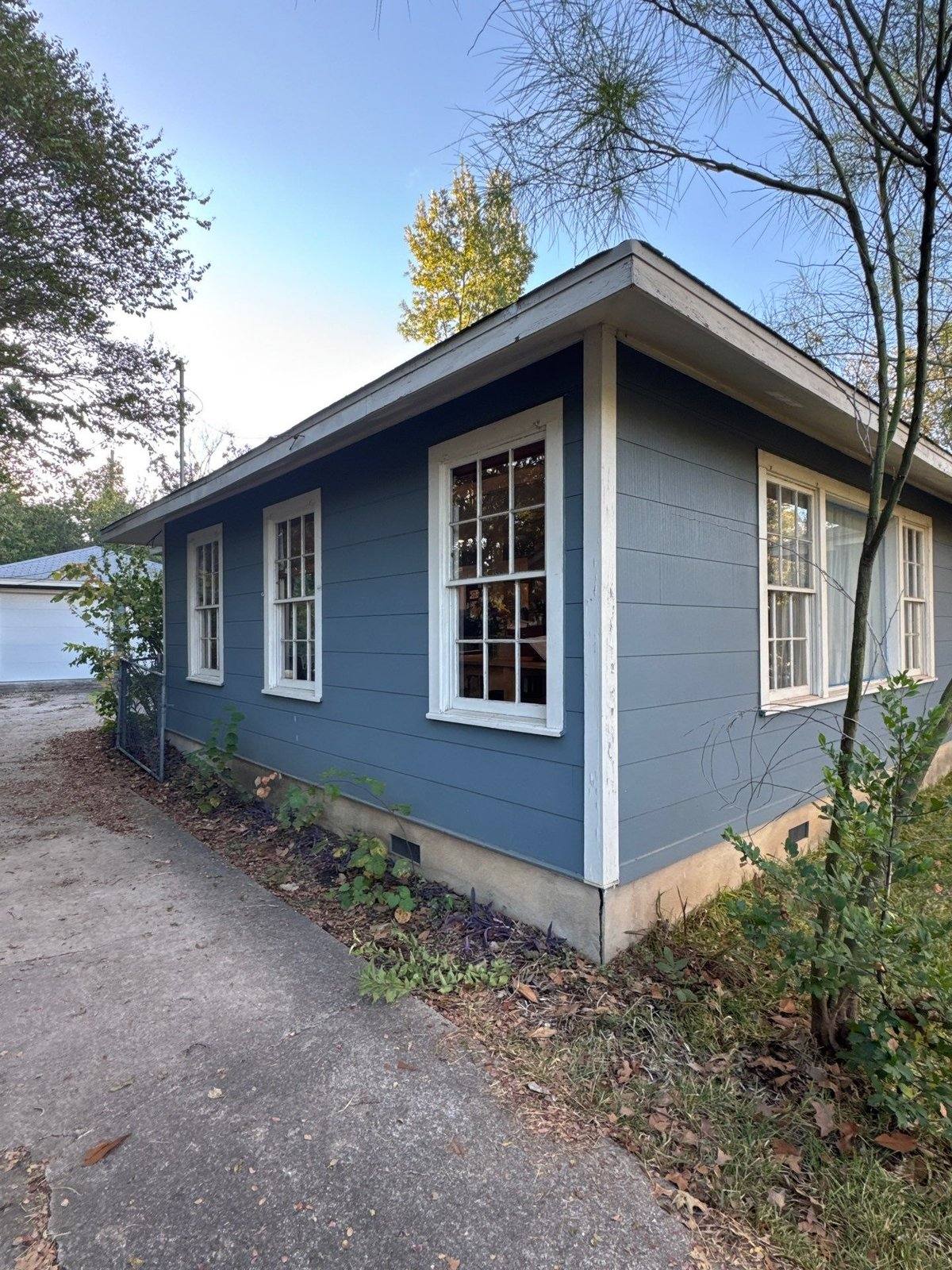 Exterior siding and trim on a one-story home in Austin, TX by Hill Country Painting