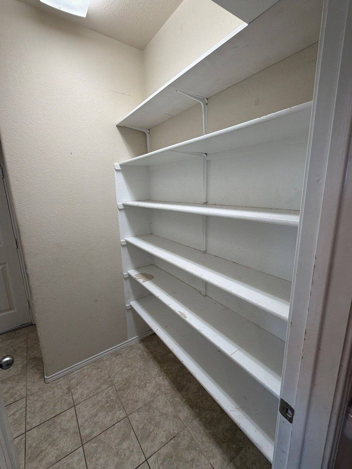 Laundry room shelving before painting and drywall work in Jarrell, TX by Hill Country Painting