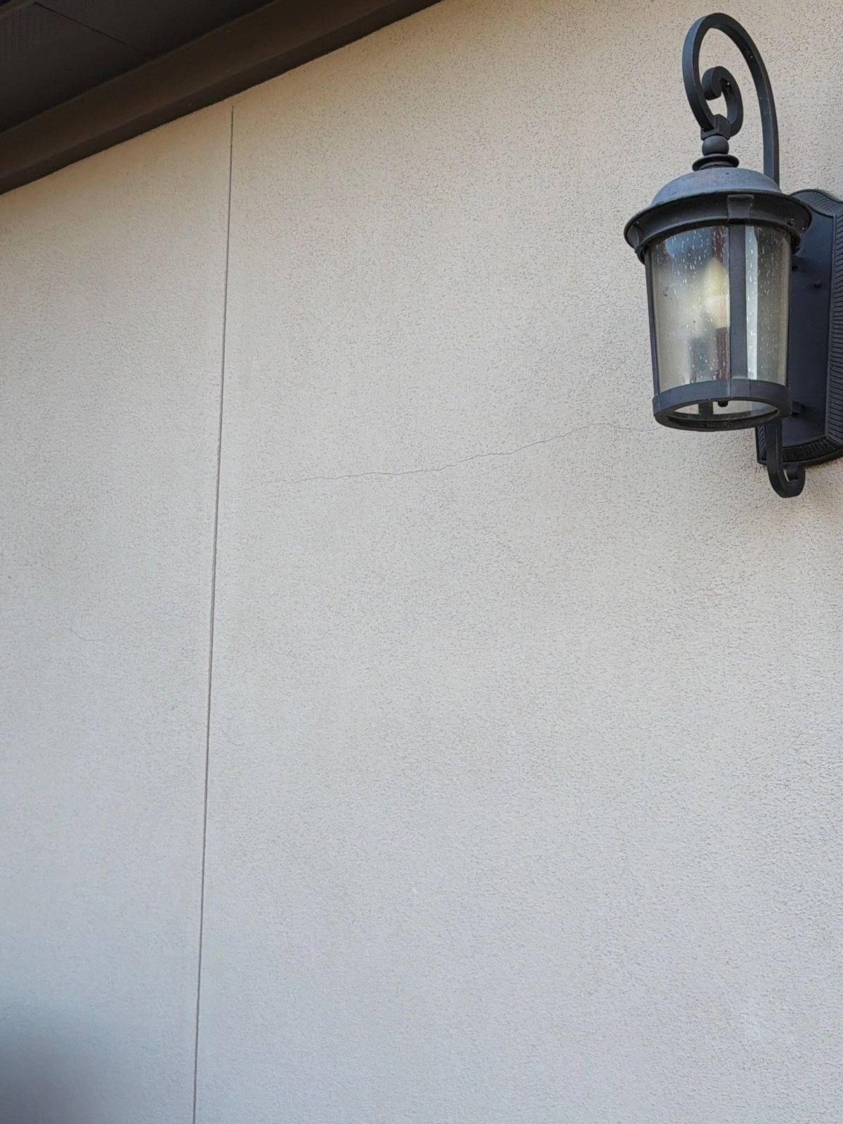 Stucco hairline crack before repair and painting in Leander, TX by Hill Country Painting