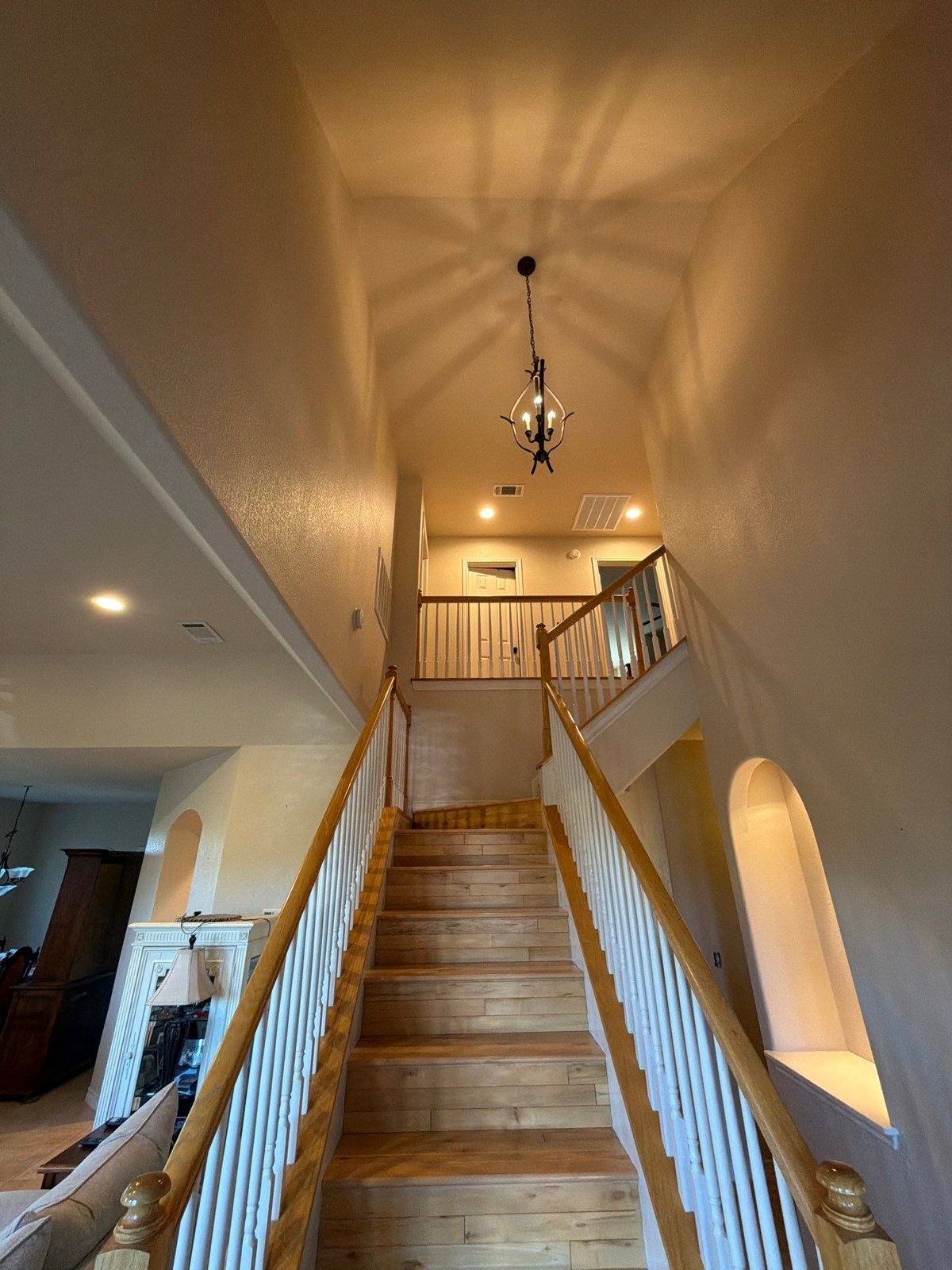 Entry way and stairwell before painting in Georgetown, TX by Hill Country Painting