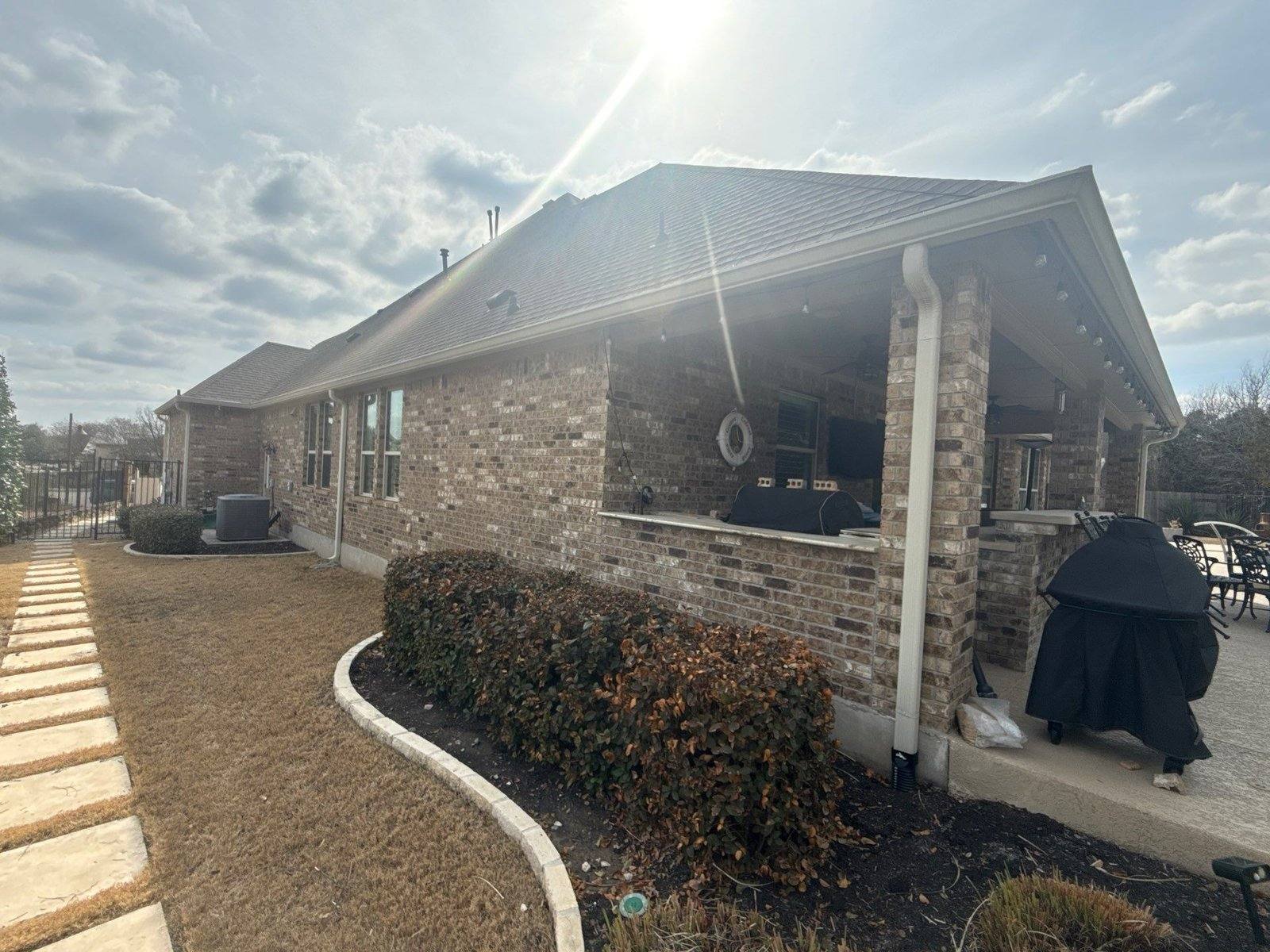 Back patio and exterior brick before painting in Georgetown, TX by Hill Country Painting
