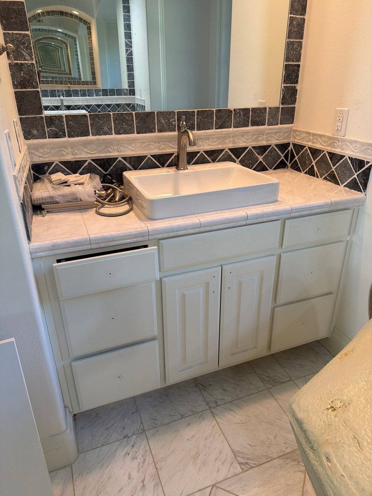 Master bathroom vanity and cabinets before painting in Austin, TX by Hill Country Painting