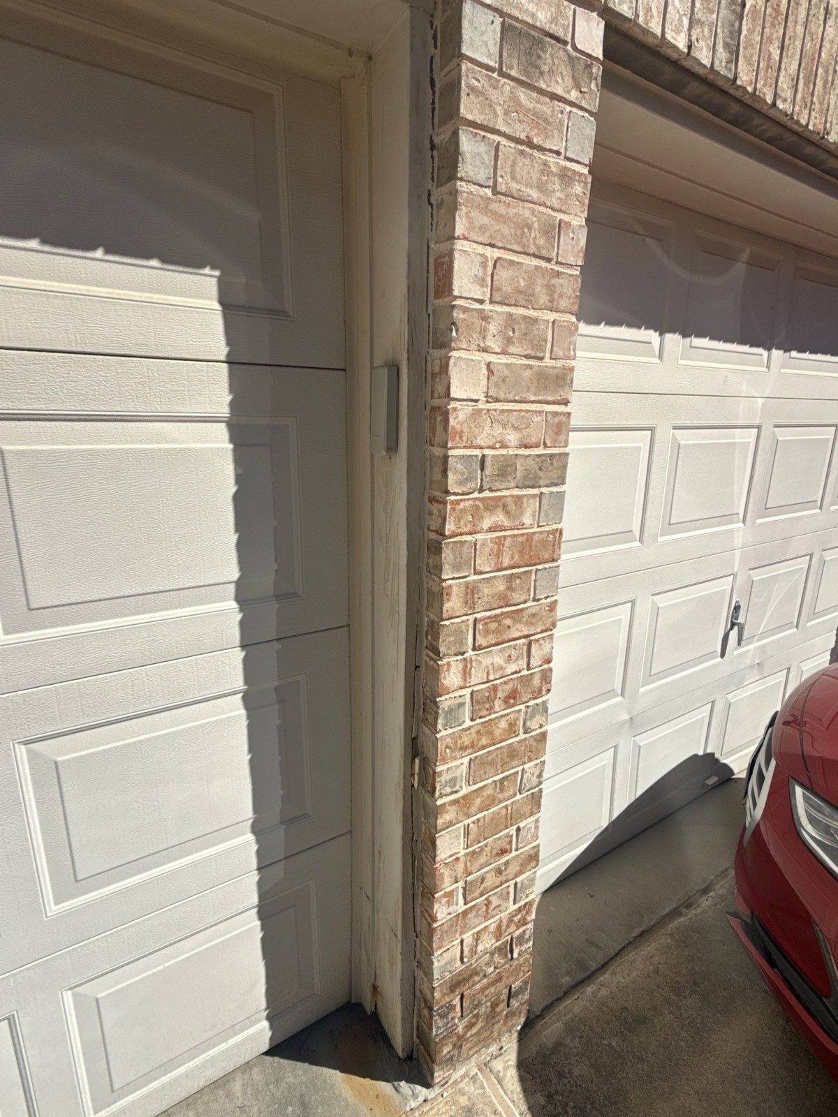 Garage door and exterior wall before painting in Round Rock, TX by Hill Country Painting