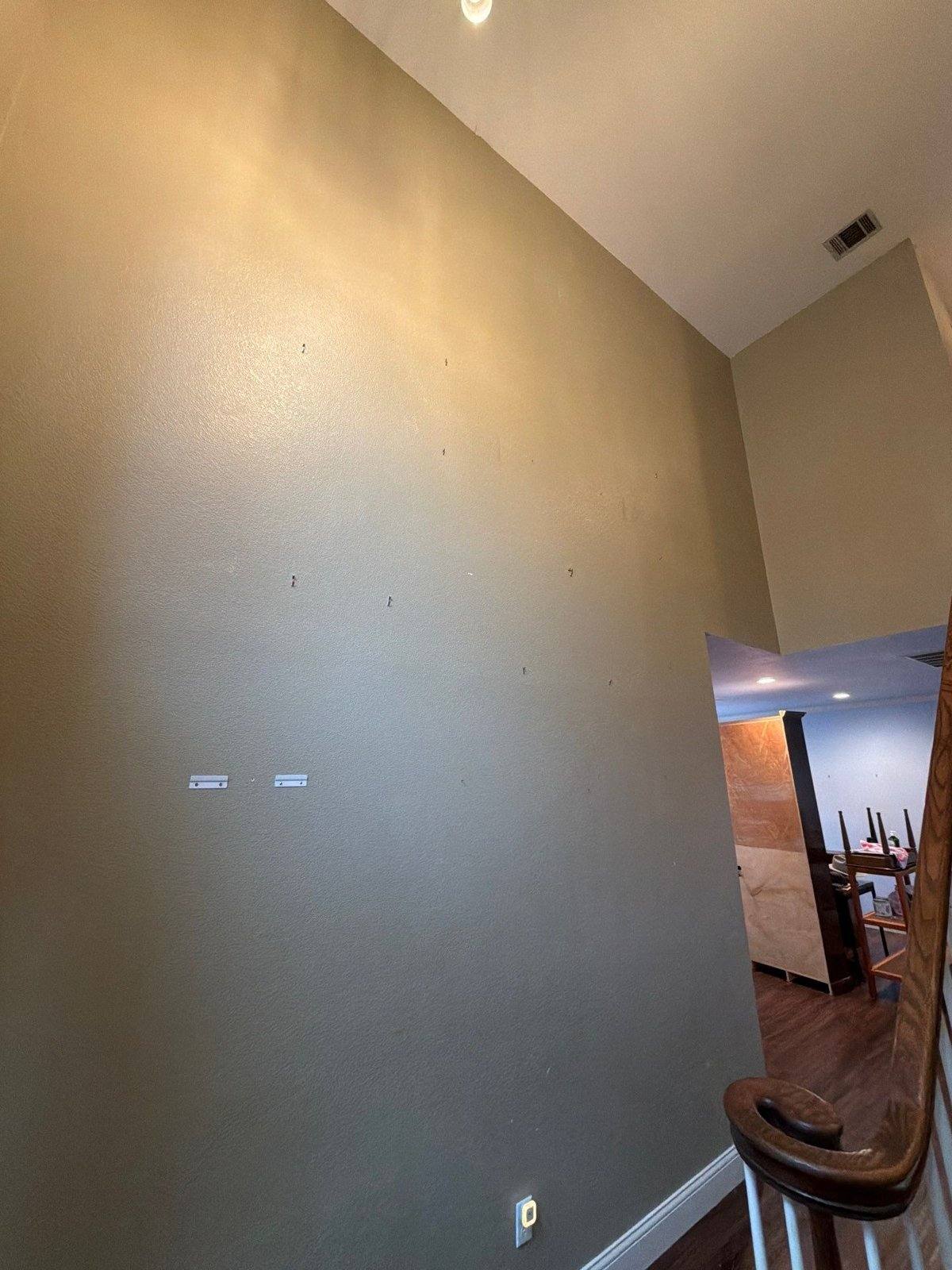 Wall ahead of nail hole repair and painting in Austin, TX by Hill Country Painting