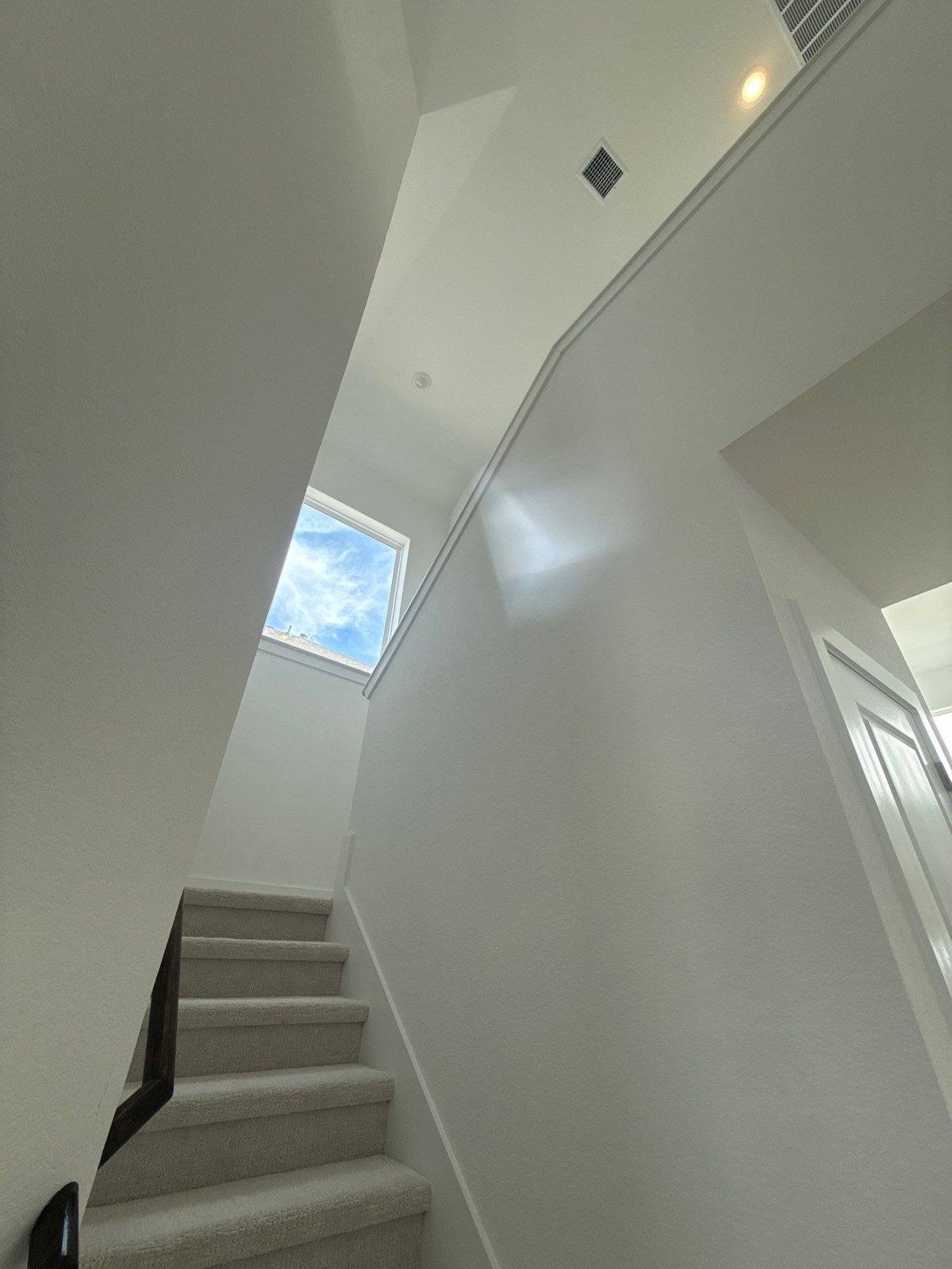 Stairwell before interior painting in Pflugerville, TX by Hill Country Painting