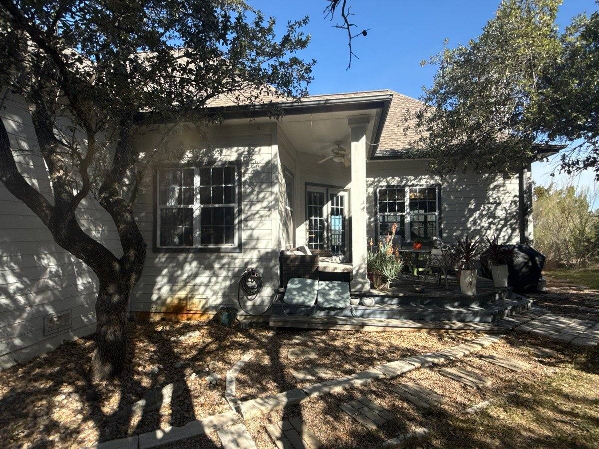 Back porch area before exterior painting in Dripping Springs, TX by Hill Country Painting
