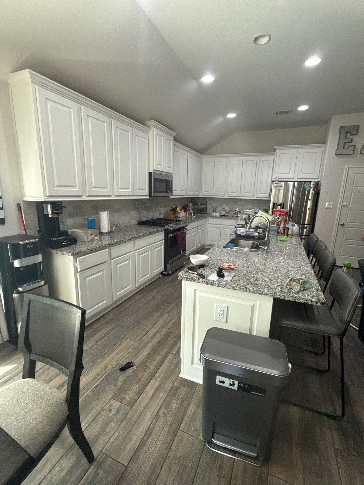 Kitchen and living room before interior painting in Georgetown, TX by Hill Country Painting