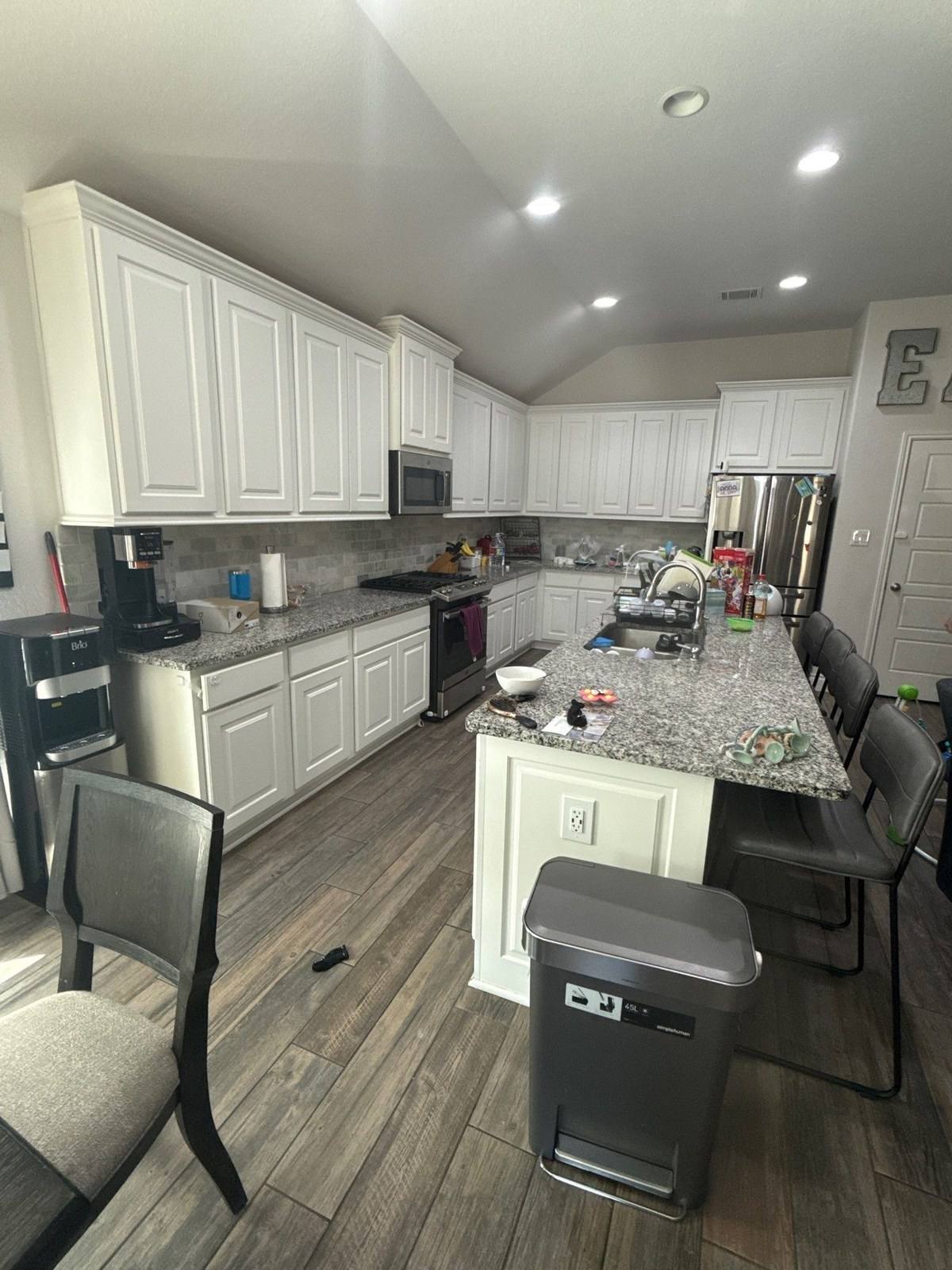 Kitchen and living room before interior painting in Georgetown, TX by Hill Country Painting